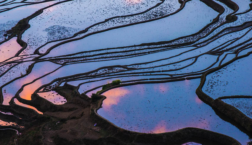A body of water reflects a beautiful sunset. Description generated by AI