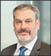 A man wearing a blue tie. Description generated by AI