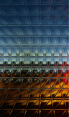 A red light is shining through a glass window. Description generated by AI