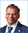 A man wearing a blue suit and tie. Description generated by AI