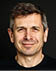 A man with a black shirt and a beard. Description generated by AI