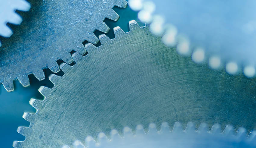 A close up of a gear with a blue background. Description generated by AI